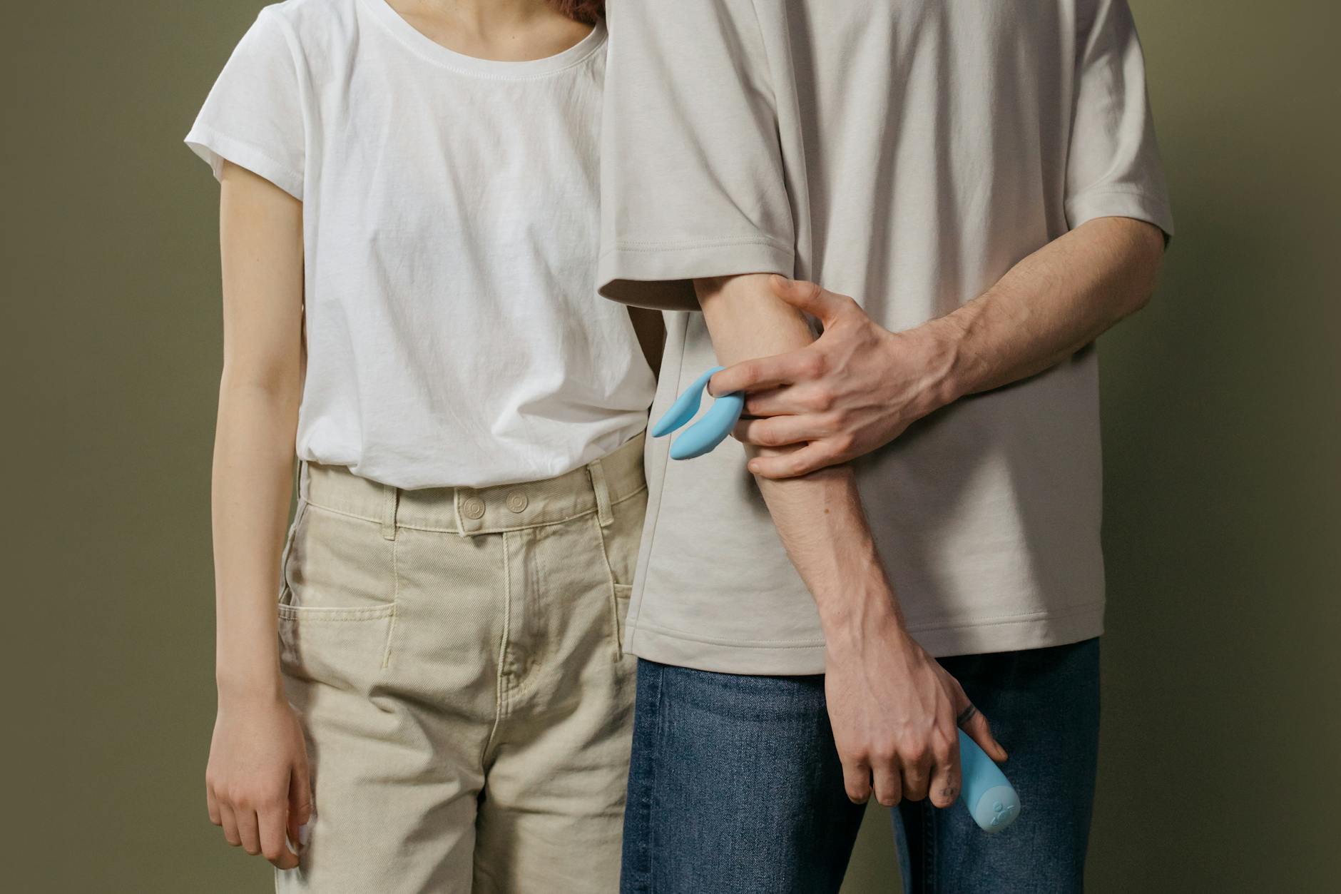 A hand holding a lemon vibrator against a minimalistic purple backdrop, symbolizing pleasure and modern sensuality.