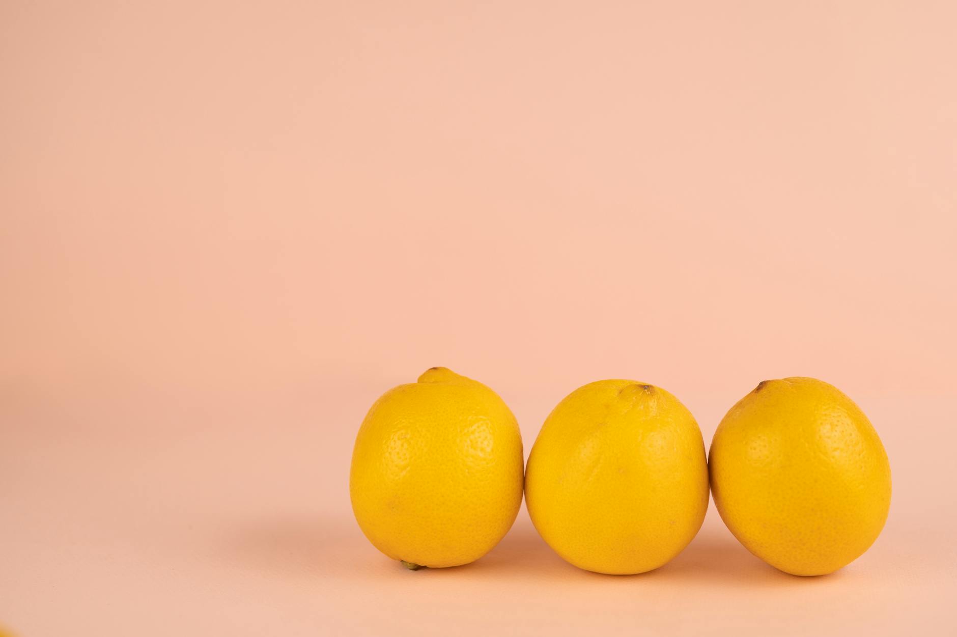 Bright ripe lemons arranged on a pastel background